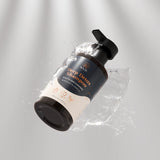 Wuli Deep Detox Shampoo bottle with water splash on a gray background