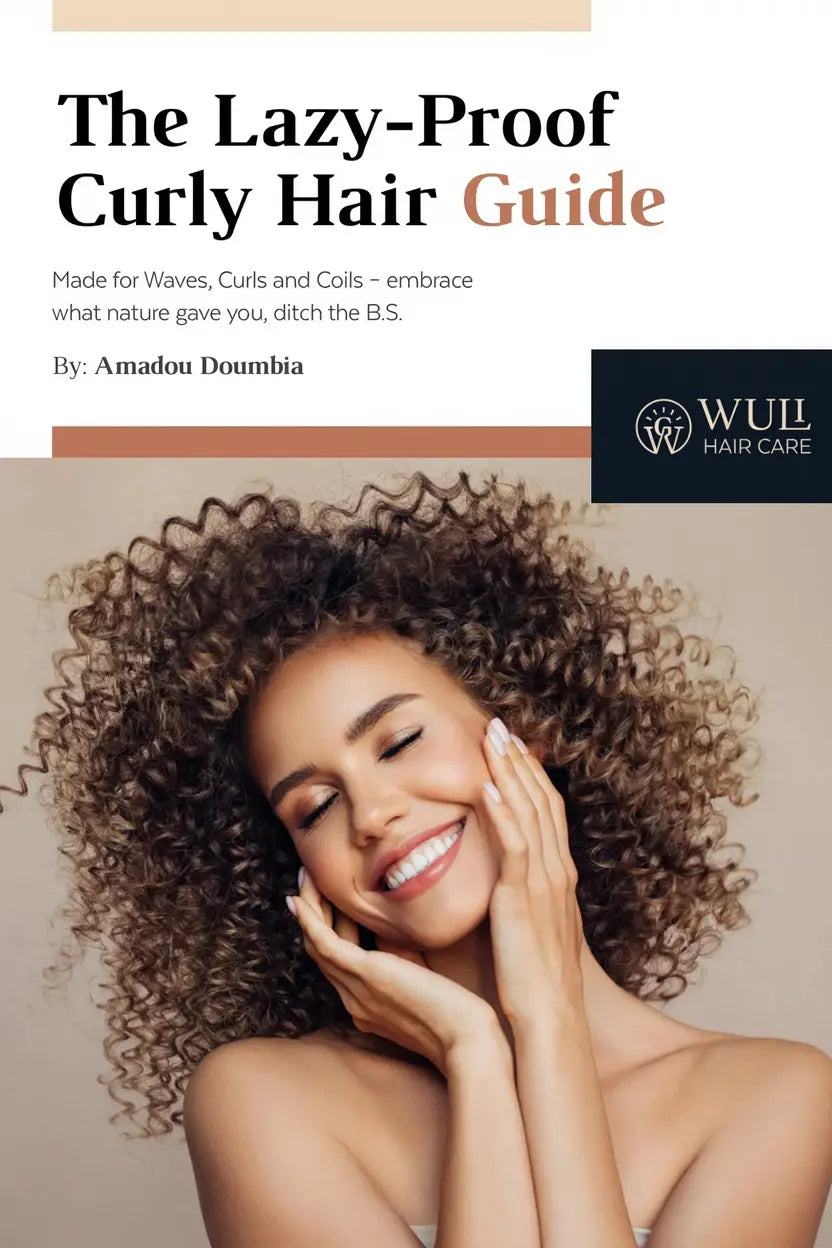 Cover of The Lazy-Proof Curly Hair Guide by Amadou Doumbia, featuring a smiling woman with beautiful curly hair touching her face, with the Wuli Hair Care logo. The subtitle reads 'Made for Waves, Curls and Coils - embrace what nature gave you, ditch the B.S.
