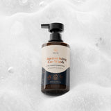 Bottle of Wuli moisturising co-wash on a textured gray background